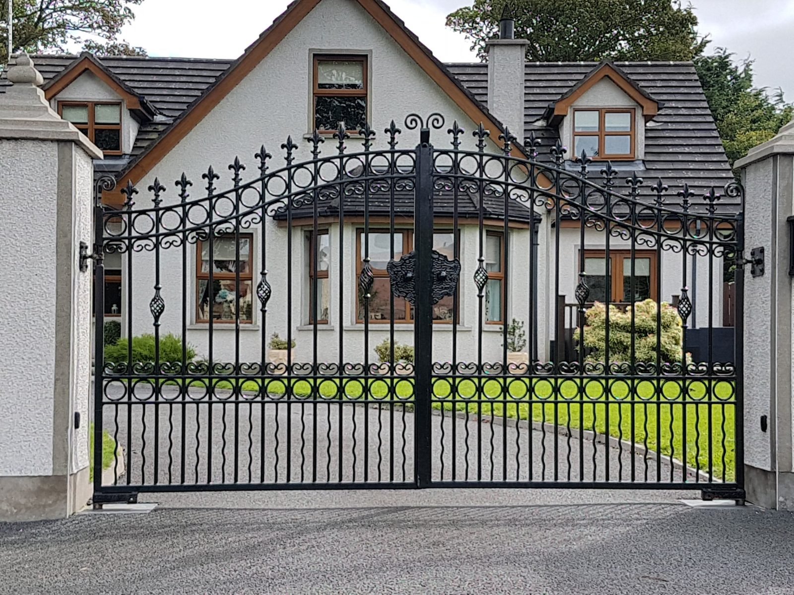 Ornate iron gates with underground motors like these for homes in Moira