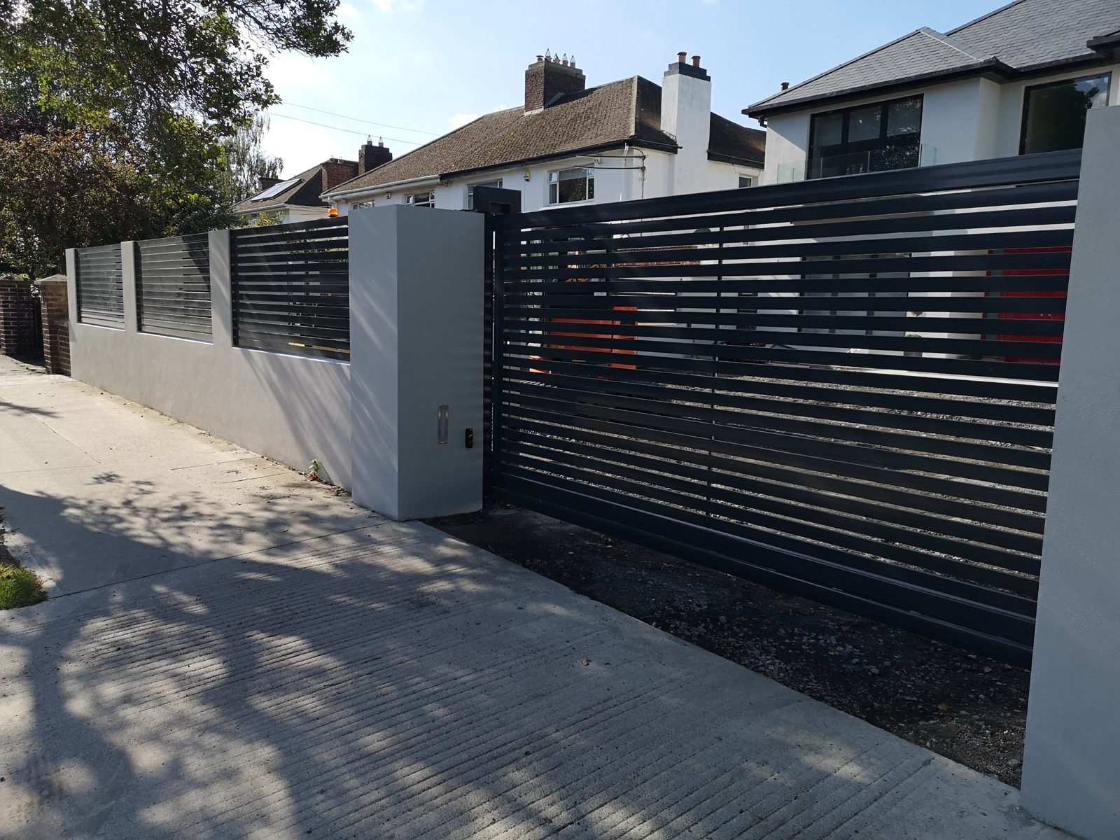 Sliding gates with matching wall panels like these for homes in Bangor